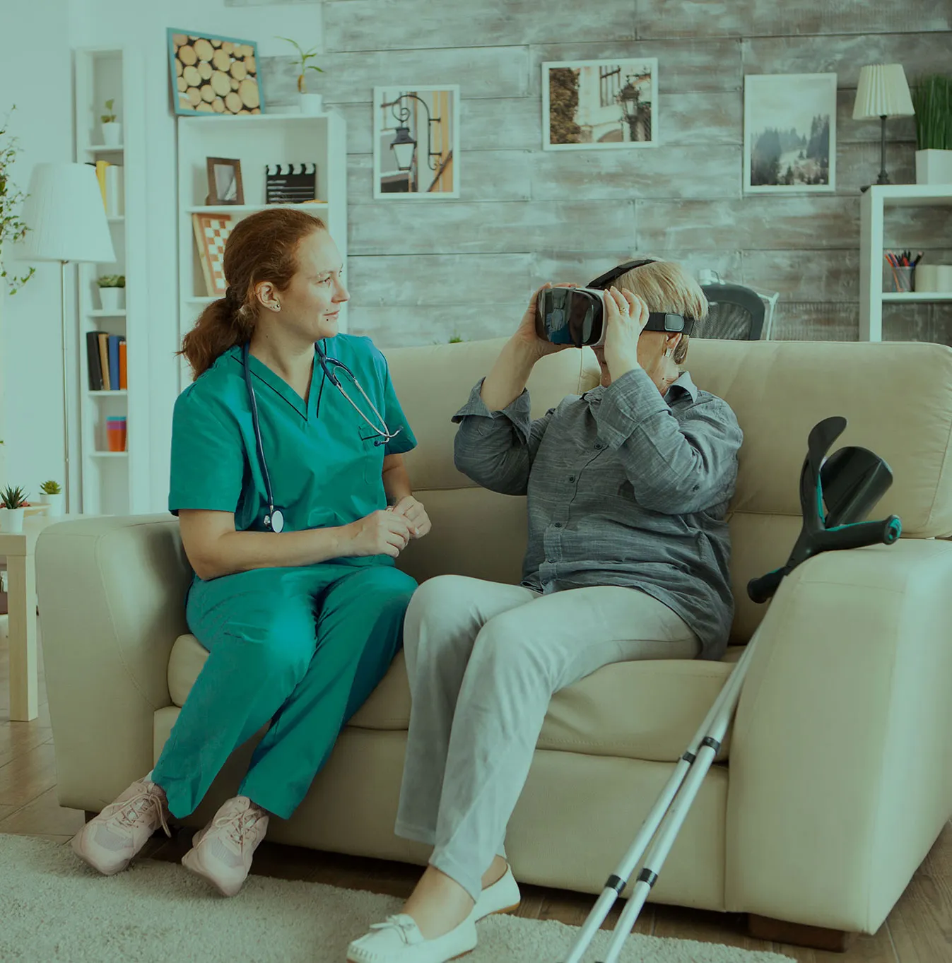 Healthcare professional assisting a senior patient at home using a VR headset for a remotion rehabilitation session.